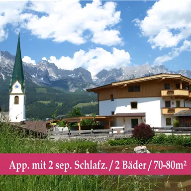 A beautiful landscape with a residential house and a church in the foreground. In the background, majestic mountains and a bright blue sky are visible.